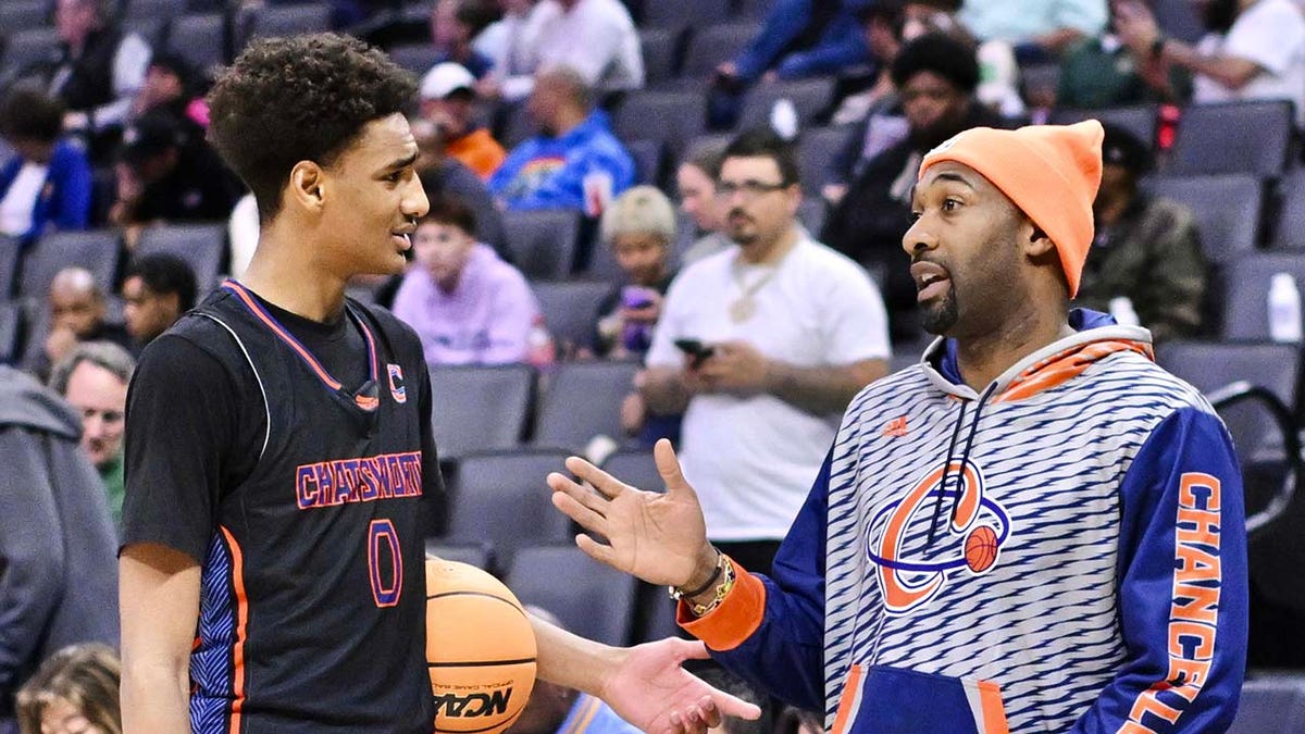 Gilbert Arenas talks with his son Alijah Arenas