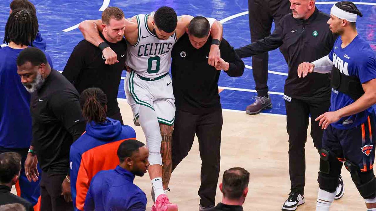 Jayson Tatum is helped off the court