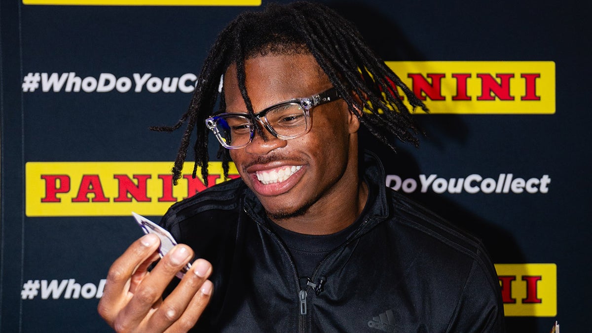 Travis Hunter opens trading card pack