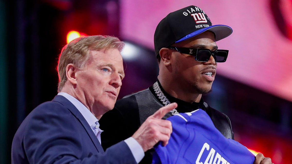 Roger Goodell and Abdul Carter on stage