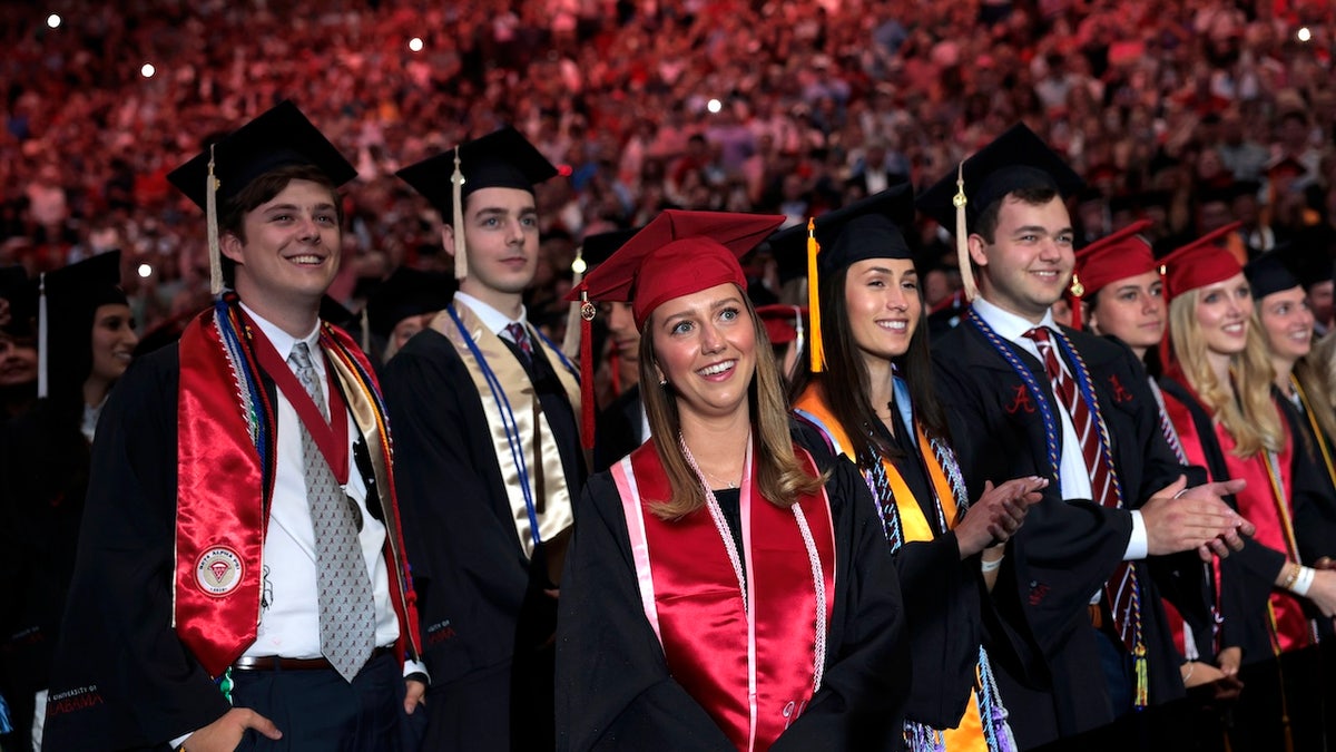 Graduating students listen to President Donald Trump's speech at the University of Alabama in Tuscaloosa on May 1, 2025. Trump's remarks came the day before official commencement ceremonies.