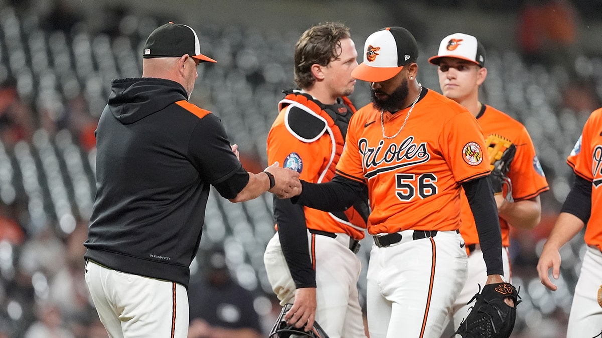 Brandon Hyde takes the ball