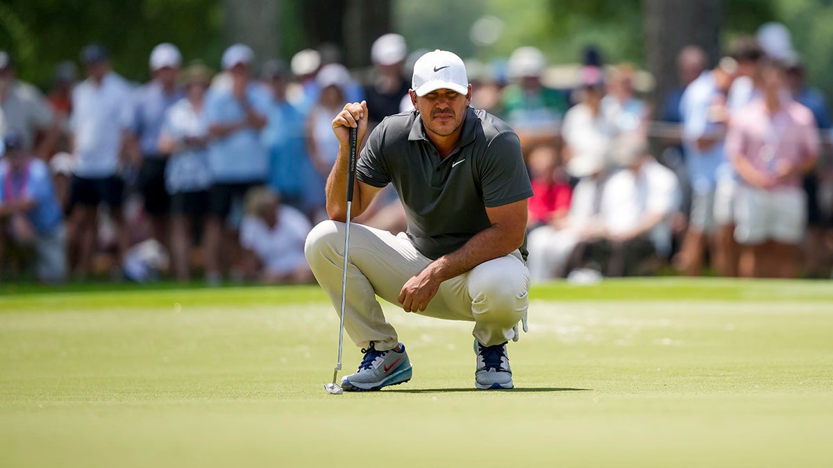 Brooks Koepka lines up putt