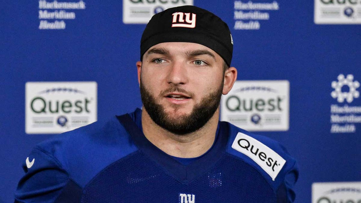 Cam Skattebo talks to reporters