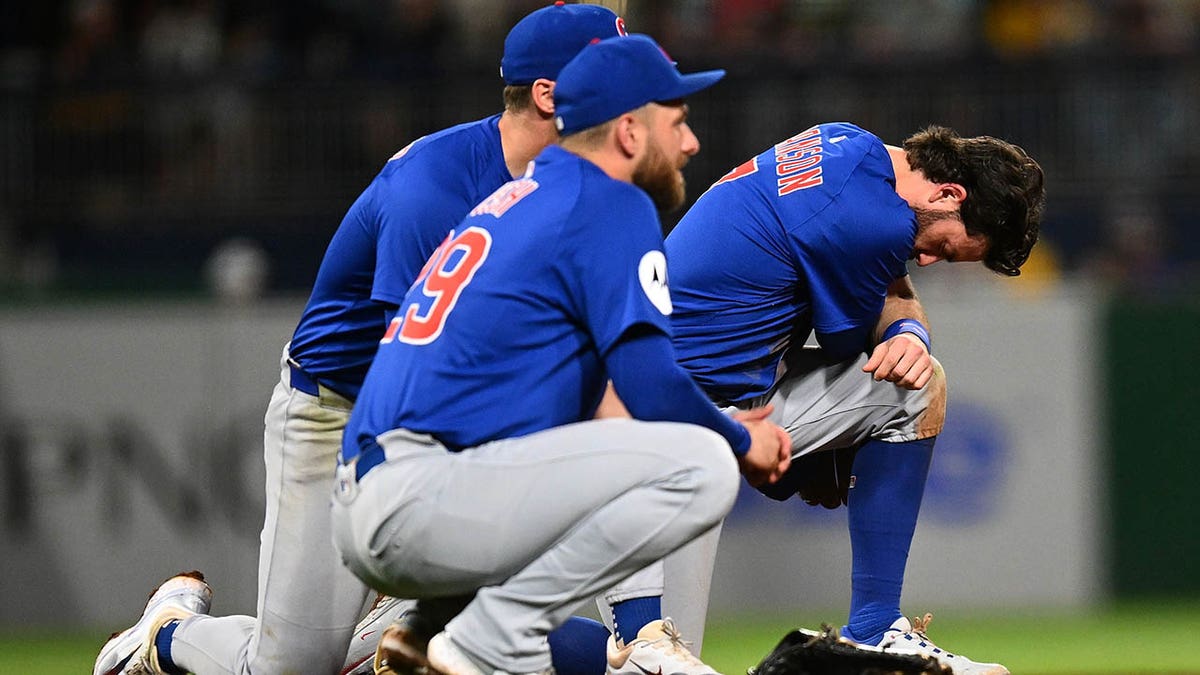 Cubs players take a knee
