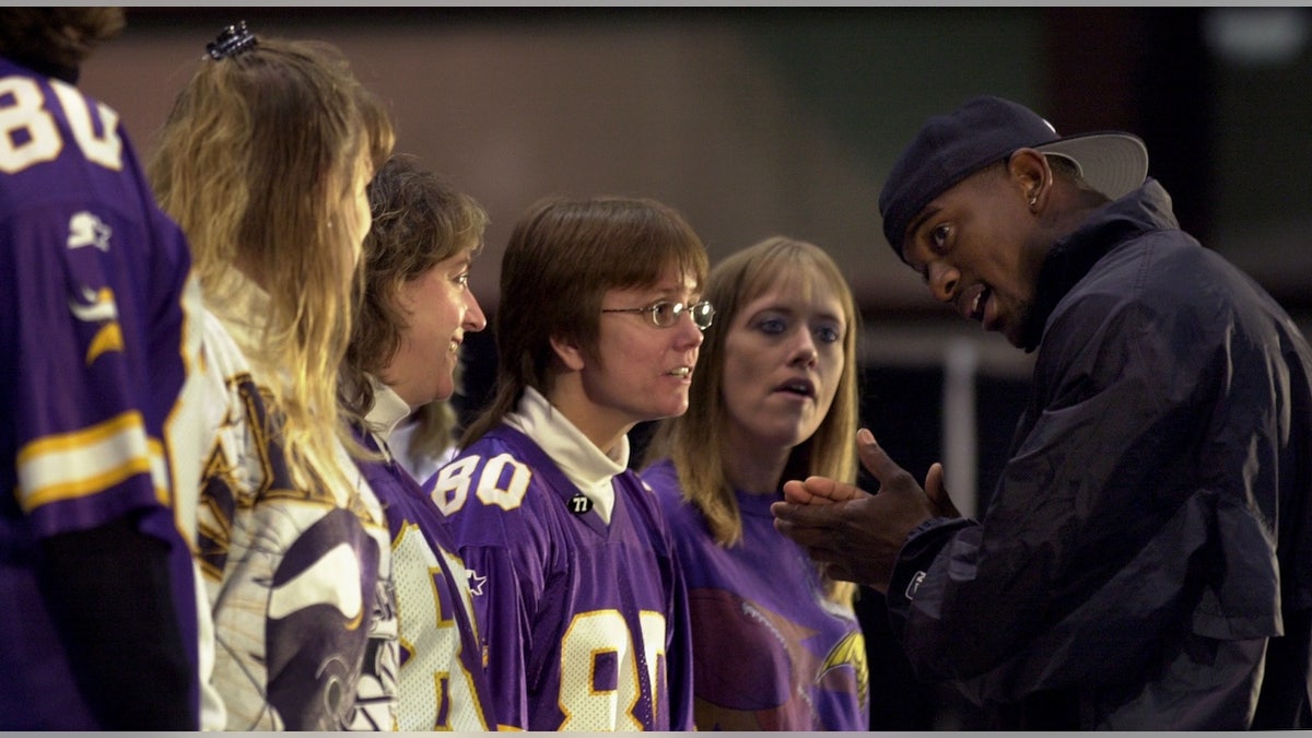 Vikings defensive back Jack Brewer, formerly a University of Minnesota defensive back, worked with a group of audience volunteers on kickoff mechanics Oct. 12, 2002.