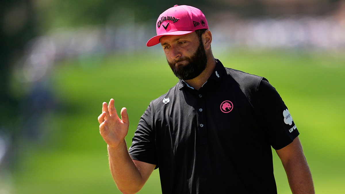 Jon Rahm waves