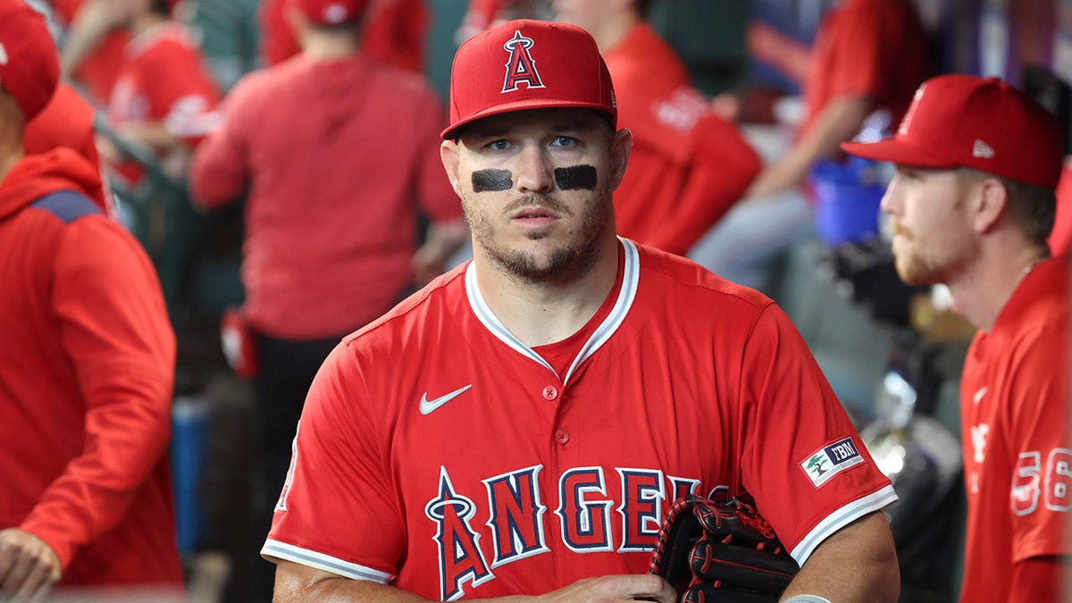 Mike Trout walks in dugout