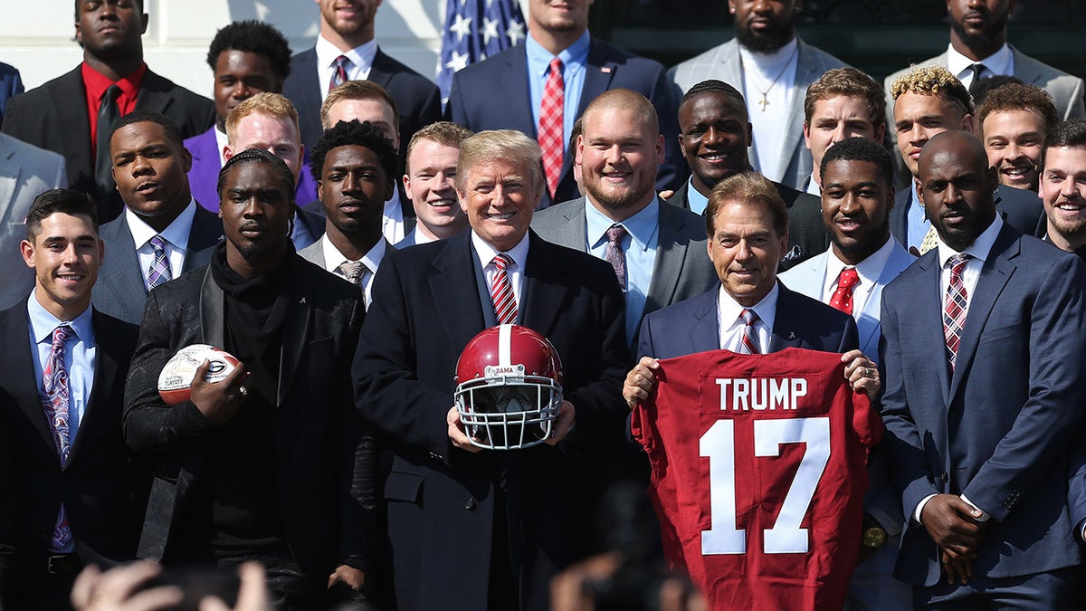 Donald Trump poses with Nick Saban and team