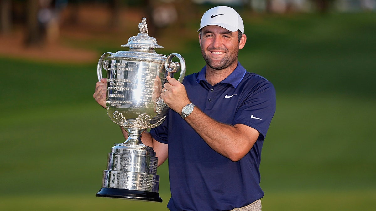 Scottie Scheffler lifts the trophy