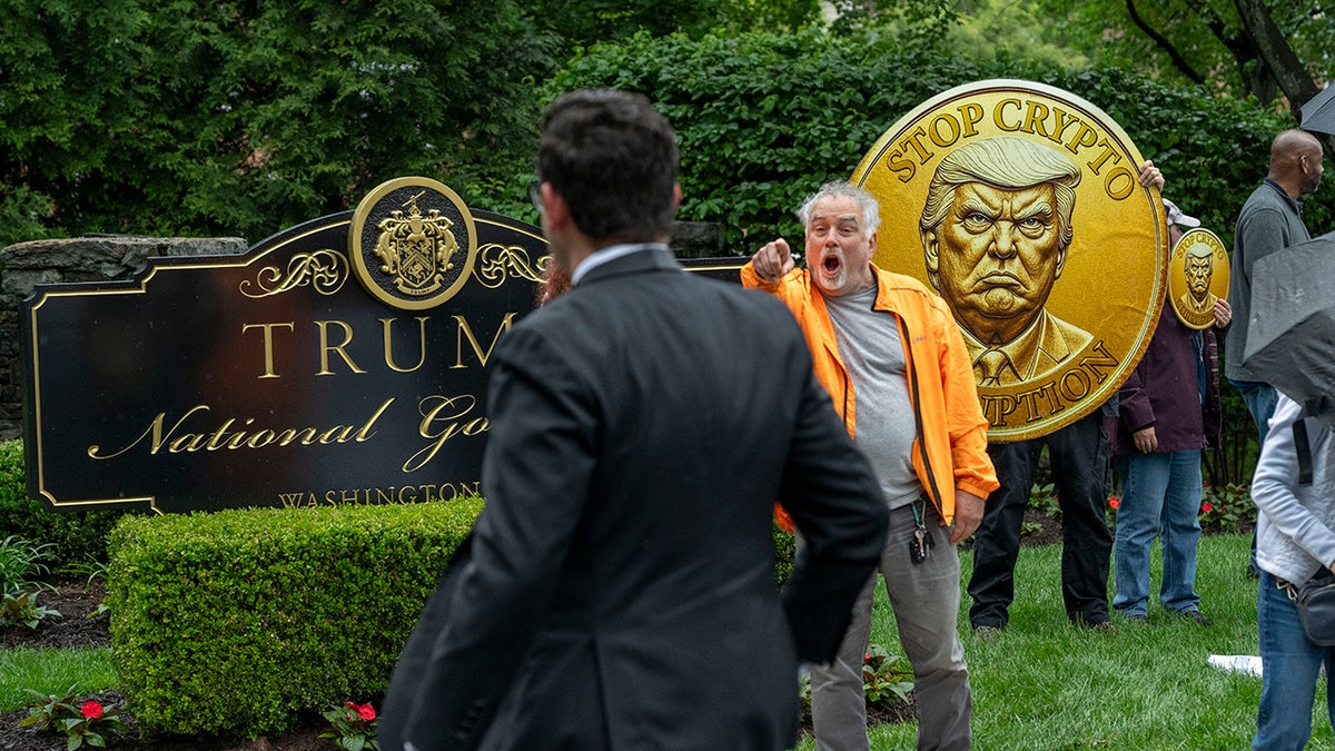 An activist calls out an attendee of an exclusive dinner at Trump National Golf Club Washington DC on Thursday, May 22.