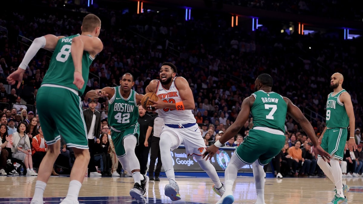 New York Knicks center Karl-Anthony Towns (32) drives to the basket against Boston Celtics centers Kristaps Porzingis (8) and Al Horford (42) and guards Jaylen Brown (7) and Derrick White (9) during the first quarter of game six in the second round of the 2025 NBA Playoffs at Madison Square Garden. 
