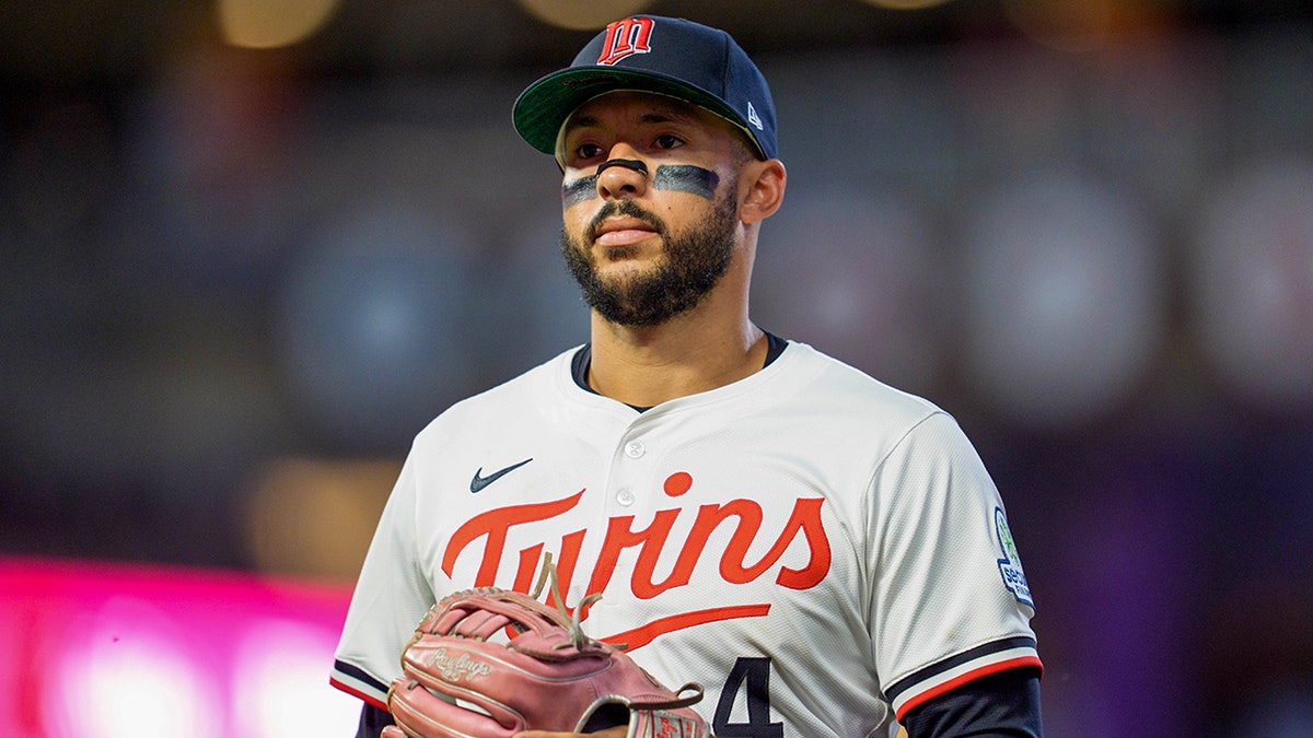 Carlos Correa looks on field