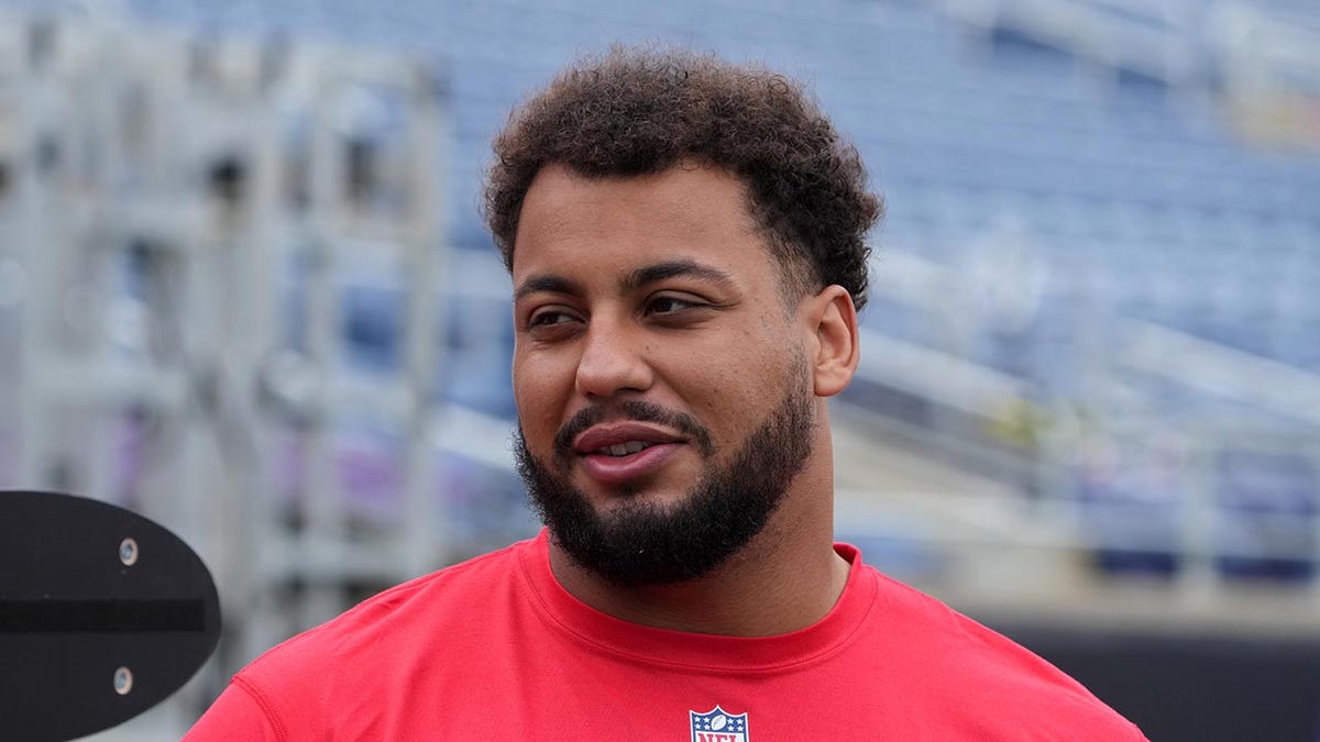 Rashawn Slater looks on field